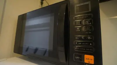 a microwave oven sitting on top of a table at tokyo sky dream shinjuku in Tokyo