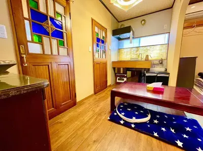 a room with a table and a kitchen with a counter at \u6728\u9999Mokkoh Modern Japanese style room by train15 minutes to Tokyo Station in Tokyo
