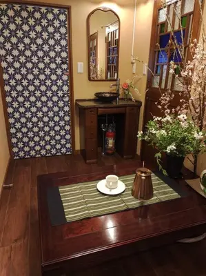 a living room with a table and a mirror at \u6728\u9999Mokkoh Modern Japanese style room by train15 minutes to Tokyo Station in Tokyo