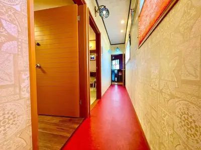 a hallway with a red floor and a wall at \u6728\u9999Mokkoh Modern Japanese style room by train15 minutes to Tokyo Station in Tokyo