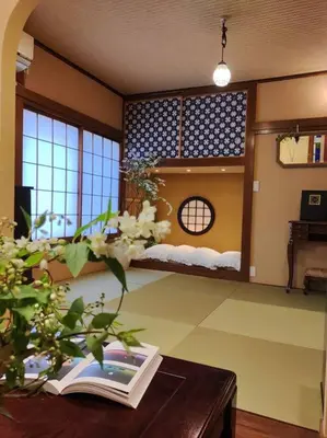 a room with a book on a table with a bed in it at \u6728\u9999Mokkoh Modern Japanese style room by train15 minutes to Tokyo Station in Tokyo