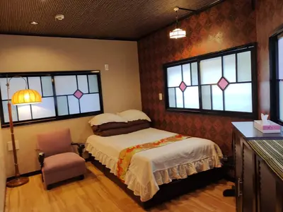 a bedroom with a bed and a chair and windows at \u6728\u9999Mokkoh Modern Japanese style room by train15 minutes to Tokyo Station in Tokyo