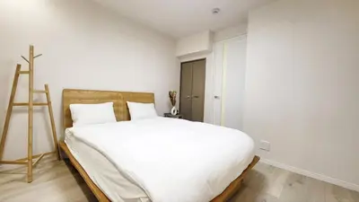 a bedroom with a white bed and a ladder at Hotel STAY ARI Higashishinjuku in Tokyo