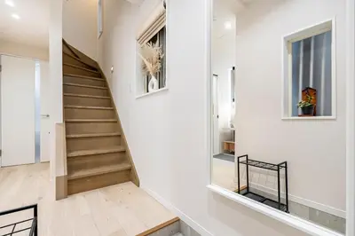 a staircase in a home with white walls and wooden floors at Hotel STAY ARI Higashishinjuku in Tokyo