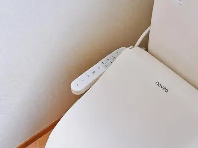 a remote control sitting on the side of a router at Evergreen Apartment Hotel in Tokyo