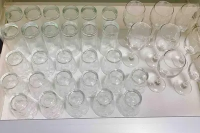 a bunch of empty wine glasses sitting on a table at Oyama - Diamond Yu in Tokyo