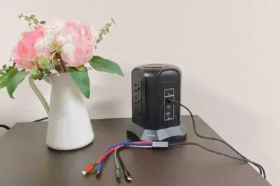 a phone and a vase with flowers on a table at Oyama - Diamond Yu in Tokyo