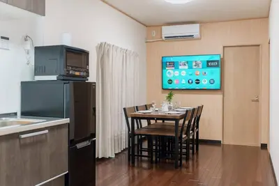 a kitchen with a table with chairs and a tv at Oyama - Diamond Yu in Tokyo