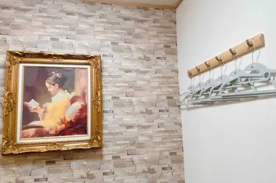 a painting of a woman on a brick wall at Oyama - Diamond Yu in Tokyo