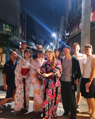 a group of people standing on a street at MAKOTO GUESTHOUSE -Limited Weight under 120kg, Age under 50years old- in Tokyo