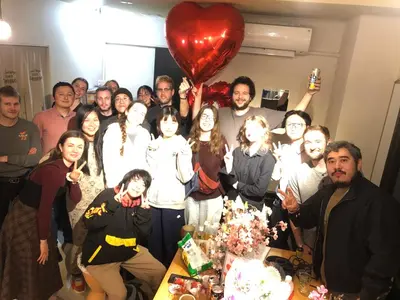 a group of people posing for a picture with a heart balloon at MAKOTO GUESTHOUSE -Limited Weight under 120kg, Age under 50years old- in Tokyo