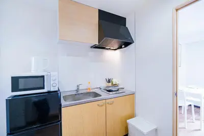 a small kitchen with a sink and a microwave at 10min walk to Shinjuku EoS9 in Tokyo