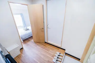 a hallway with a mirror and a room with a bed at 10min walk to Shinjuku EoS9 in Tokyo