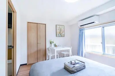 a white bedroom with a bed and a desk at 10min walk to Shinjuku EoS9 in Tokyo
