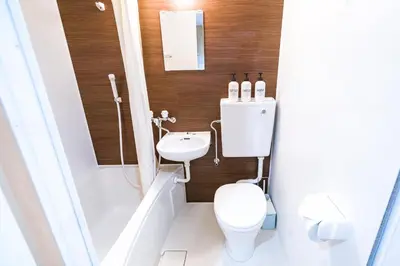 a small bathroom with a toilet and a sink at 10min walk to Shinjuku EoS9 in Tokyo