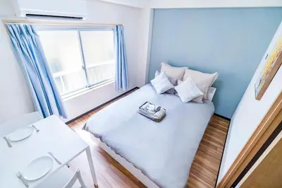 a small bedroom with a bed with a tray on it at 10min walk to Shinjuku EoS9 in Tokyo