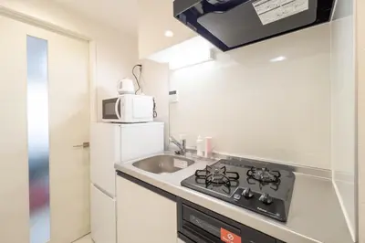 a small kitchen with a sink and a microwave at aLATO\u9326\u7cf8\u753a in Tokyo