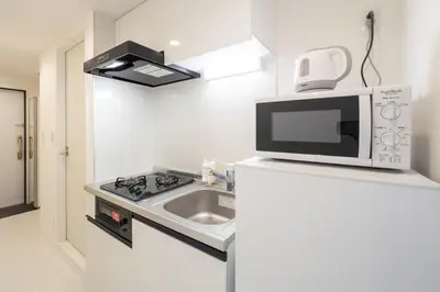 a kitchen with a microwave and a sink at aLATO\u9326\u7cf8\u753a in Tokyo