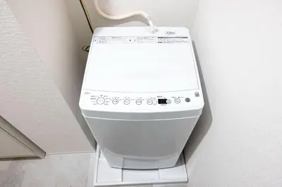 a white toilet in a corner of a room at aLATO\u9326\u7cf8\u753a in Tokyo