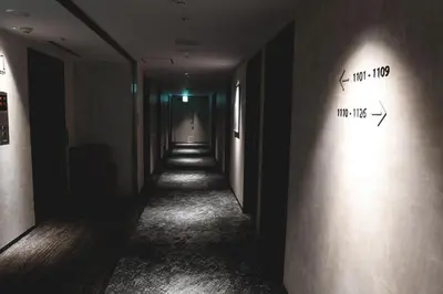 a hallway with a long hallway with writing on the wall at Washington R&B Hotel Otsuka Eki Kitaguchi in Tokyo