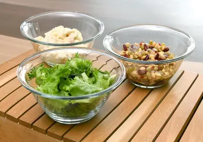 three bowls of food sitting on a wooden table at WASHINGTON R&B Hotel Ueno Hirokoji in Tokyo