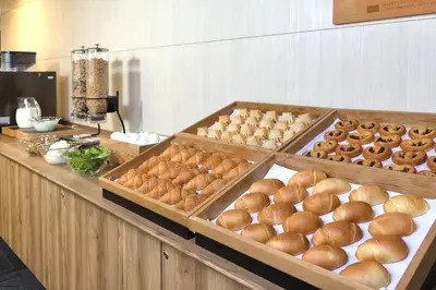 a buffet line with buns and other food on display at WASHINGTON R&B Hotel Ueno Hirokoji in Tokyo