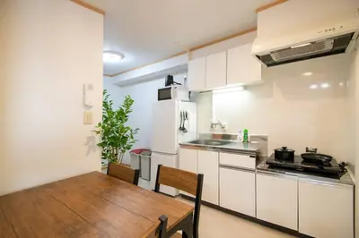 a kitchen with a wooden table and a dining room at Rea\u65b0\u5c0f\u5ca92\u4e01\u76ee403 in Tokyo