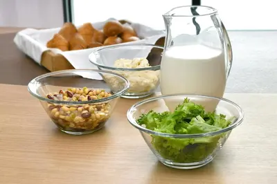 a table with four bowls of food and a jug of milk at Washington R&BHotel TokyoToyocho in Tokyo