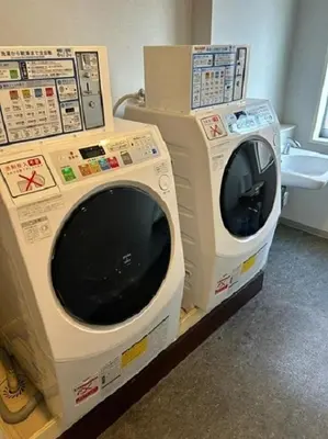 two washing machines sitting next to each other in a room at Washington R&BHotel TokyoToyocho in Tokyo