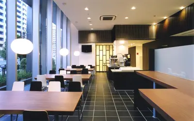 a dining room with tables and chairs and windows at Washington R&BHotel TokyoToyocho in Tokyo