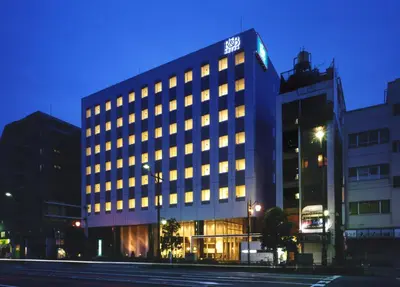 a building with lights on in a city at night at Washington R&BHotel TokyoToyocho in Tokyo