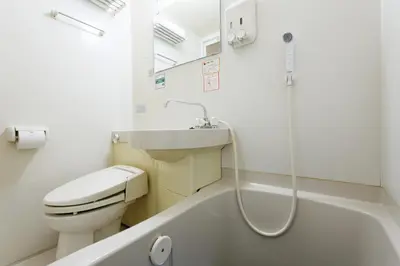a bathroom with a toilet and a sink and a bath tub at WashingtonR&B Hotel Kamata Higashiguchi in Tokyo
