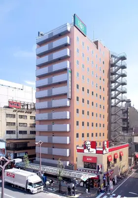 a tall building with a sign on the side of it at WashingtonR&B Hotel Kamata Higashiguchi in Tokyo