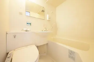 a white bathroom with a toilet and a bath tub at WashingtonR&B Hotel Kamata Higashiguchi in Tokyo