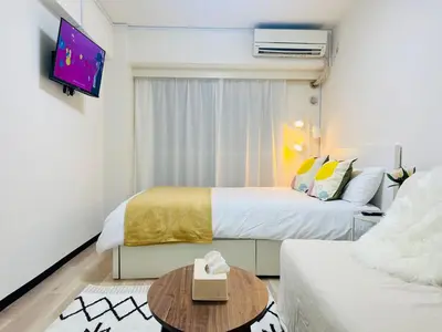 a hotel room with two beds and a tv at Kabukicho 203-SJ0015 in Tokyo