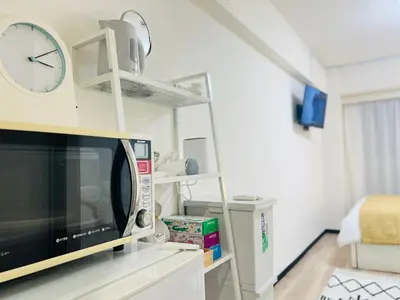 a room with a tv and a clock on the wall at Kabukicho 203-SJ0015 in Tokyo