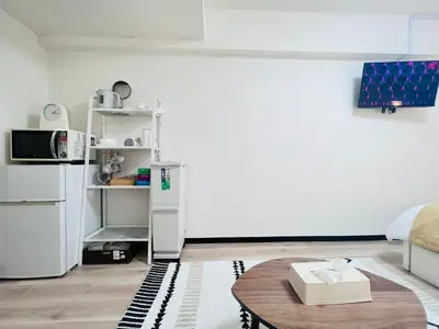 a living room with a table and a refrigerator at Kabukicho 203-SJ0015 in Tokyo