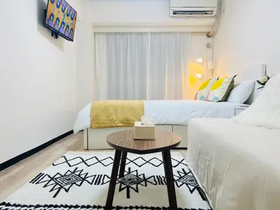 a small room with two beds and a table at Kabukicho 203-SJ0015 in Tokyo