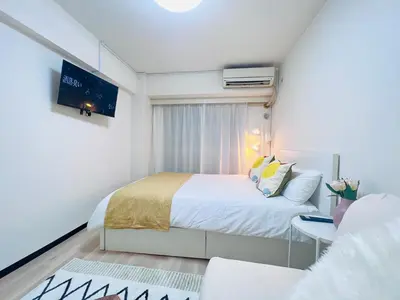 a small bedroom with a bed and a tv at Kabukicho 203-SJ0015 in Tokyo
