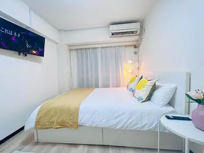 a bedroom with a white bed and a tv at Kabukicho 203-SJ0015 in Tokyo