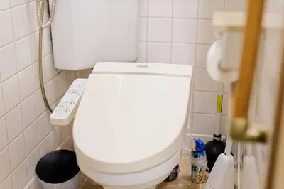 a bathroom with a white toilet with a remote control at Tokyo Shinjuku hotel in Tokyo
