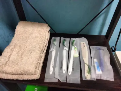 a shelf with three toothbrushes and a towel at \u548c\u98a8\u5ba2\u68e7 in Tokyo