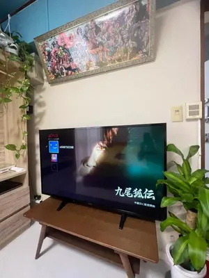 a flat screen tv sitting on top of a wooden table at \u548c\u98a8\u5ba2\u68e7 in Tokyo