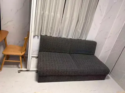 a couch sitting in front of a window with a chair at \u548c\u98a8\u5ba2\u68e7 in Tokyo