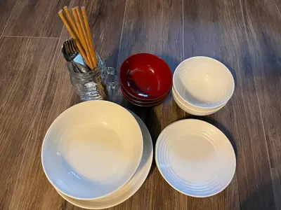 three white plates sitting on a wooden table with chopsticks at Cozy inn Oyama in Tokyo