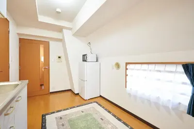 a kitchen with a refrigerator and a window at \u65e7 DeLCCS\u5c71\u5439\u795e\u697d\u5742III in Tokyo