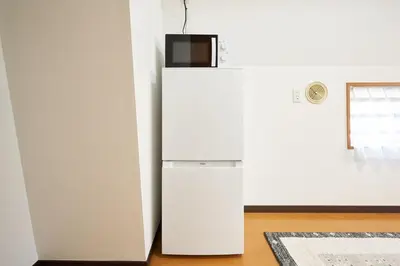 a white refrigerator in a room with a window at \u65e7 DeLCCS\u5c71\u5439\u795e\u697d\u5742III in Tokyo