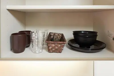 a shelf with bowls and other items on it at \u65e7 DeLCCS\u5c71\u5439\u795e\u697d\u5742III in Tokyo