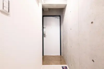 a hallway with a door in a building at Ferio\u84b2\u7530II in Tokyo