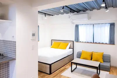 a small bedroom with a bed and a couch at Gran Fusion\u6c60\u888b in Tokyo